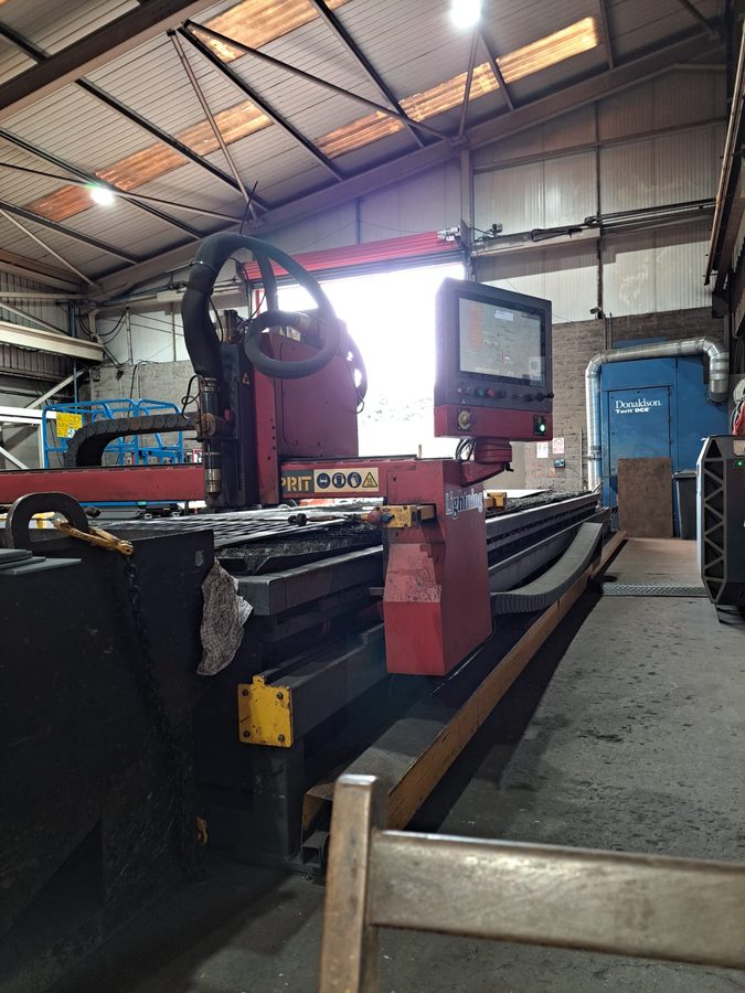 CNC plasma cutting table in a fabrication shop